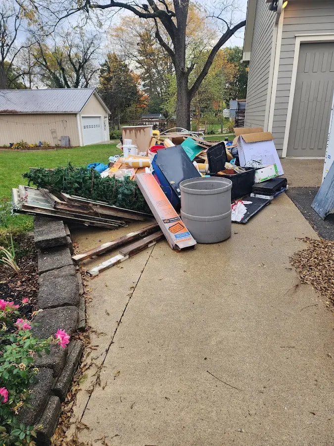 Dumpster being loaded with debris for Estate Cleanout Dumpster Rental in Kinross